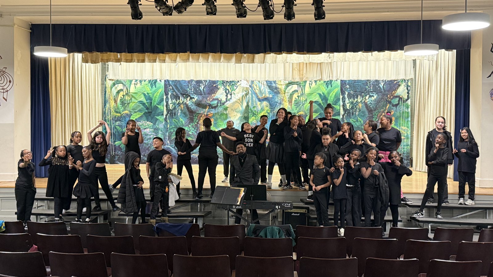 Mal directing a large student choir performance